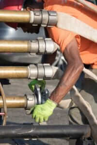 Technician working on tightening water hoses at a client facility 